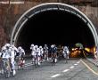 The racers exit the tunnel on the mountain pass.